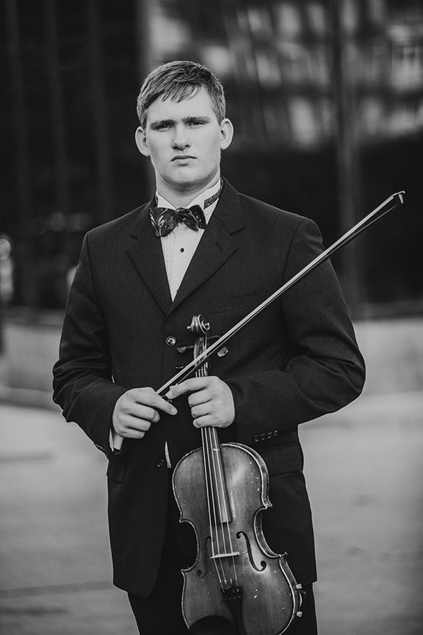 creative senior musical photoshoot of boy holding an instrument taken by Carmilla Jane Photography of Columbus, OH